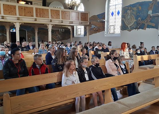 Uczniowie i nauczyciele w kościele na uroczystej mszy z okazji rozpoczęcia nowego roku szkolnego.