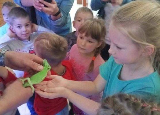 Dzieci trzymają kameleona