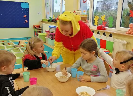 Nauczycielka pokazuje dzieciom, jak używać pęsety