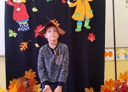 Uczeń stoi i recytuje wiersz o jesieni