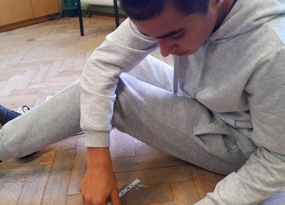 Uczeń pomaga przy segregowaniu kartek