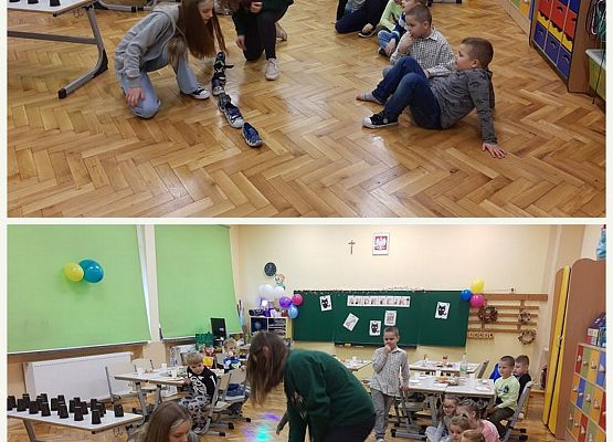 Uczniowie siedzą na podłodze i przekładają buty