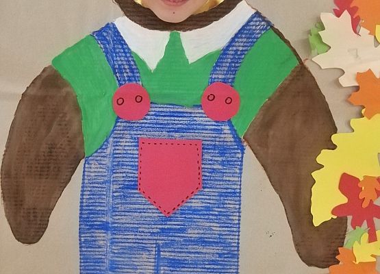 Dziecko pozuje do zdjęcia w makiecie misia