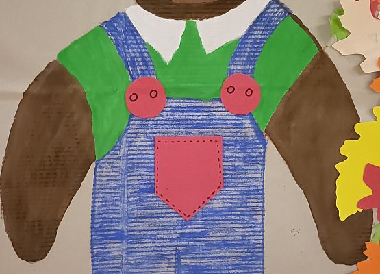 Dziecko pozuje do zdjęcia w makiecie misia