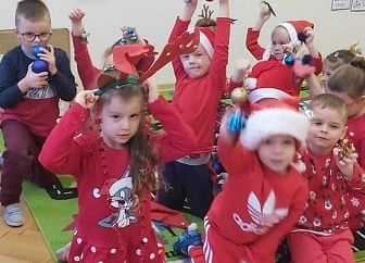 Grupa dzieci siedzi na dywanie