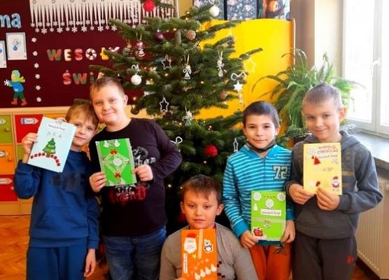 Zdjęcie grupowe. Uczniowie trzymają kartki