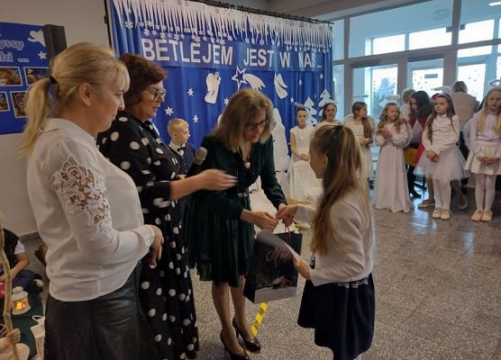 Pani wicedyrekor wręcza uczennicy nagrodę.