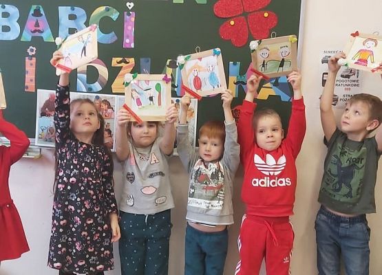 dzieci prezentują wykonane laurki dla babć i dziadków