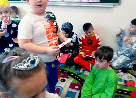 Dzieci siedzą na dywanie