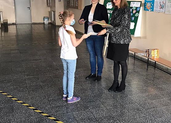 Pani wicedyrektor i pedagog wręczają uczennicy dyplom