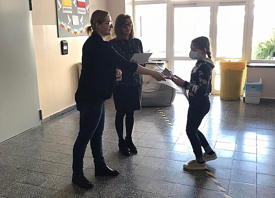 Pani wicedyrektor i pedagog wręczają uczennicy dyplom