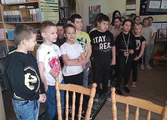 Uczniowie stoją w bibliotece