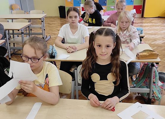 Uczennice wycinają i przyklejają kartki