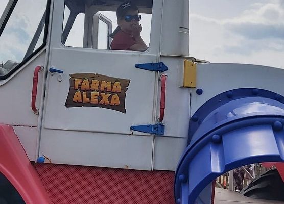 Chłopiec wygląda przez okno maszyny rolniczej