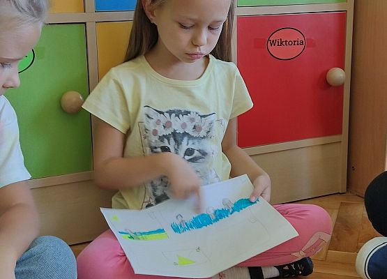 uczennica prezentuje rysunek wspomnień wakacyjnych