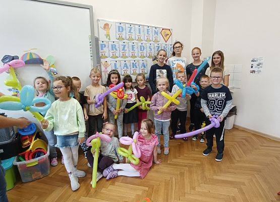 Przedszkolaki z delegacją Samorządu Uczniowskiego prezentują balony