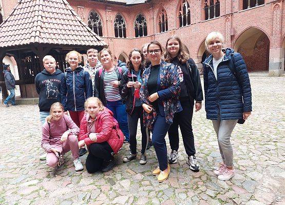 Uczniowie klasy 6 z nauczycielkami przed zamkiem