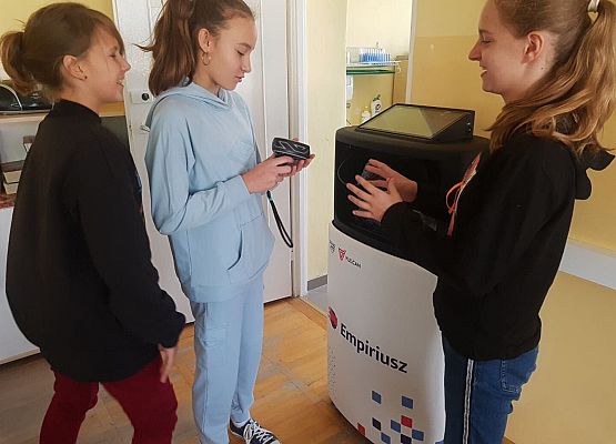 Dziewczynki stoją obok empiriusza