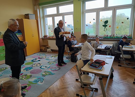 Pan dyrektor dzieli się z uczniami chlebem