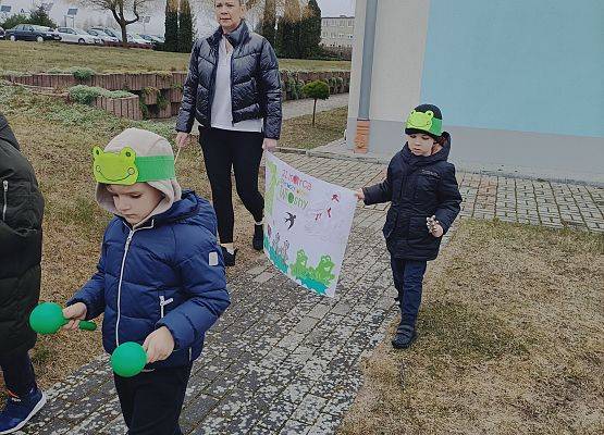 dzieci niosą plakat z napisem wiosna