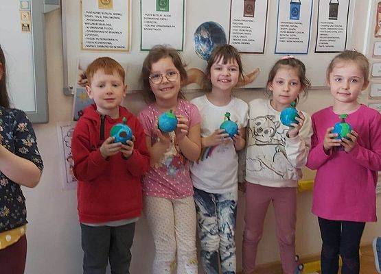 zdjęcie grupowe dzieci prezentujących niebieskie kule