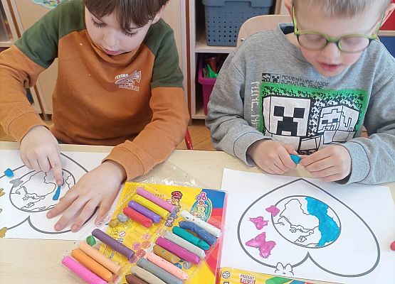 chłopcy kolorują kredkami
