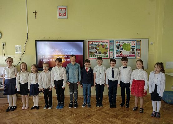 uczniowie stoją w strojach galowych