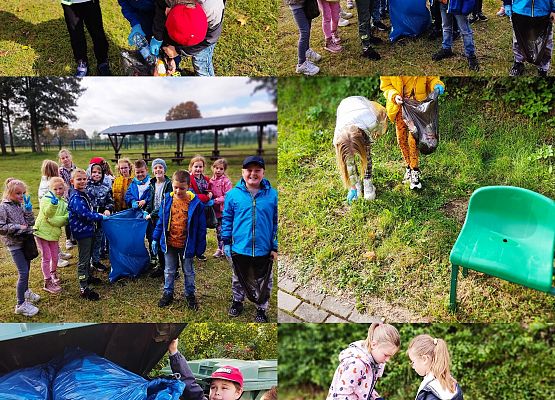 uczniowie sprzątają teren przy szkole