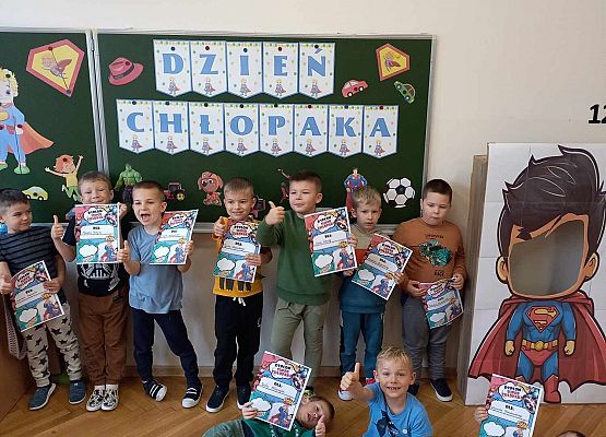 chłopcy pokazują otrzymane dyplomy