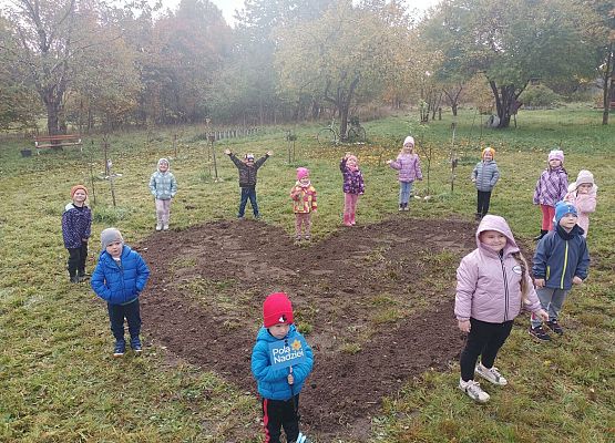dzieci stoją w miejscu, w którym posadzili żonkile