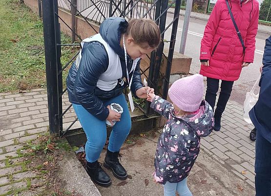 dziewczynka wrzuca darowiznę do puszki