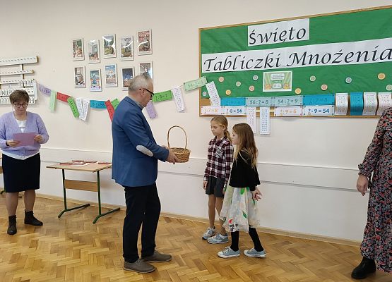 dyrektor częstuje dzieci słodyczami