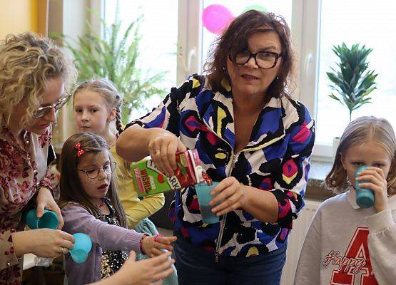 nauczycielki wlewają w kubeczki sok dla uczniów