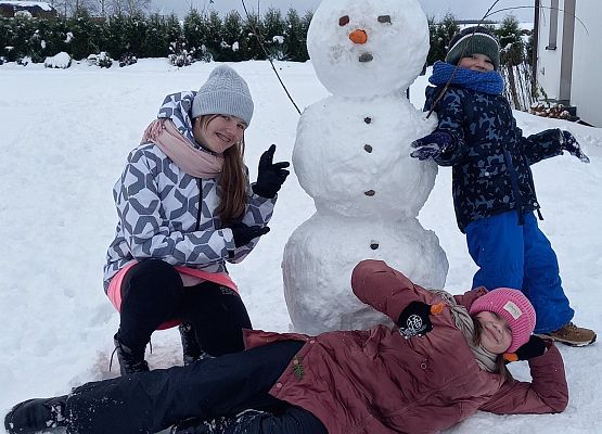 dzieci obok bałwana