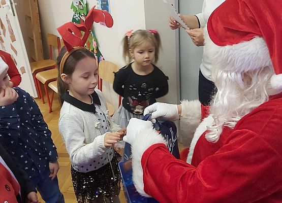 Mikołaj wręcza dzieciom prezenty