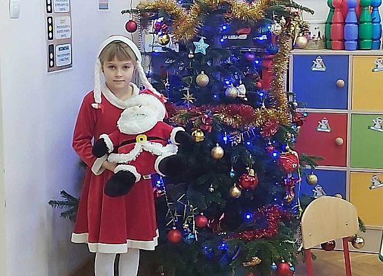 dziewczynka stoi przy choince