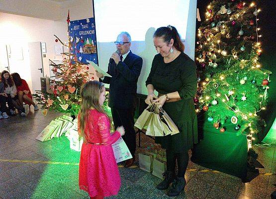 uczennica odbiera nagrodę i dyplom