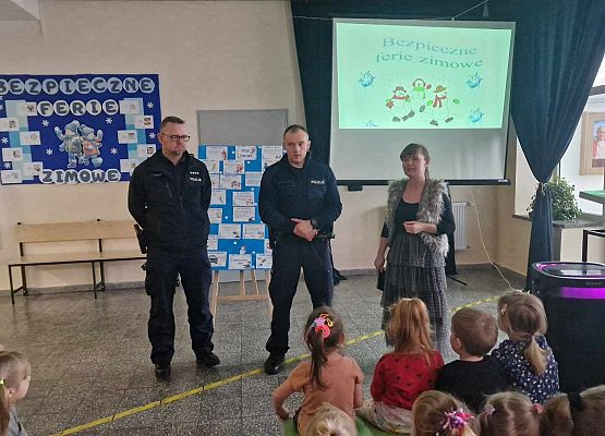 policjanci omawiają z dziećmi zasady bezpieczeństwa podczas ferii