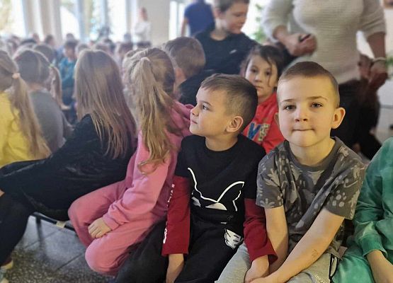 dzieci siedzą podczas zajęć