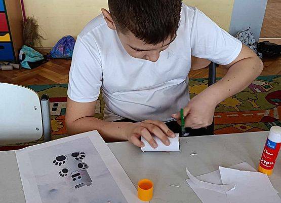 chłopiec wykonuje pracę plastyczno - techniczną