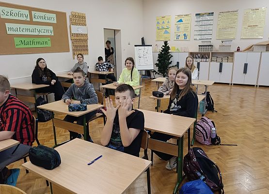 uczestnicy konkursu siedzą przy stolikach