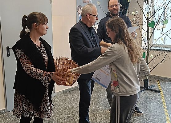 uczennica odbiera dyplom i nagrodę