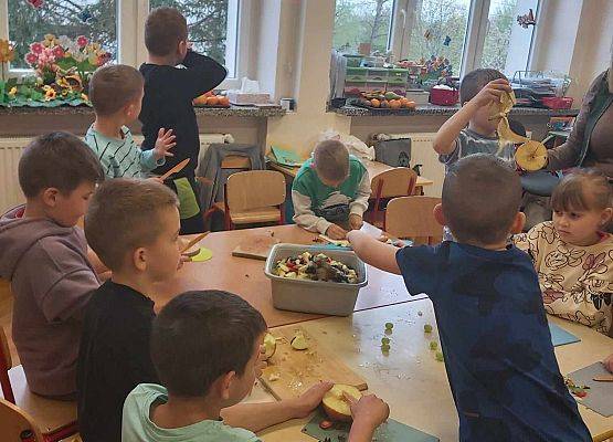 dzieci przygotowują sałatkę owocową