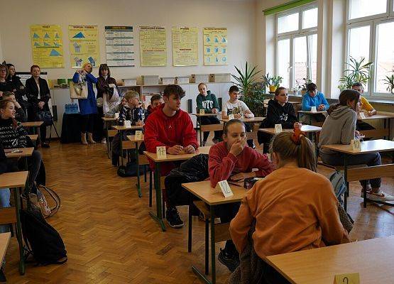 zawodnicy siedzą przy stolikach