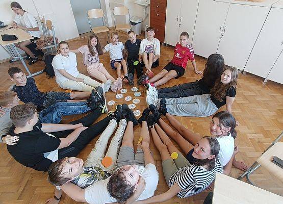 uczniowie siedzą w kręgu