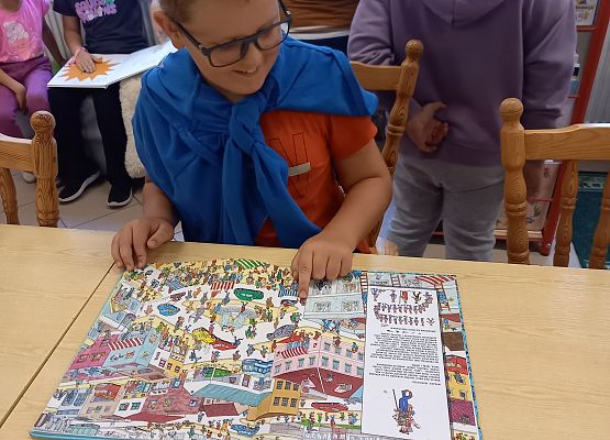 uczniowie oglądają książki