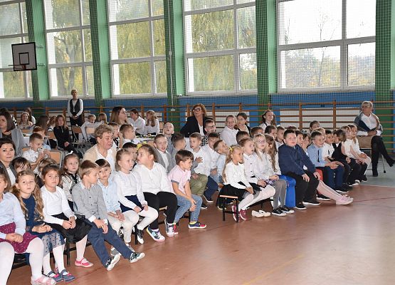 dzieci siedzą na ławkach