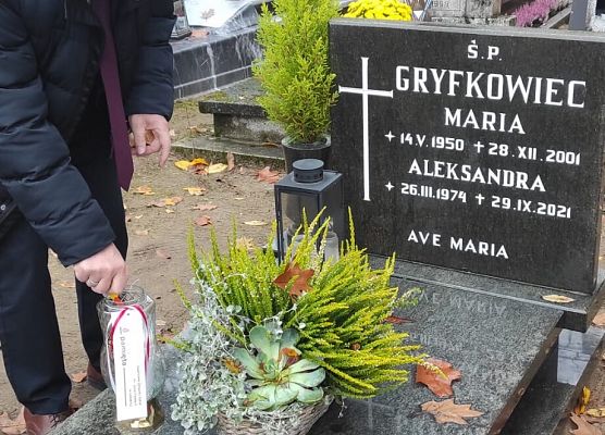 dyrektor szkoły zapala znicz