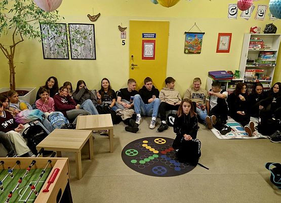 wolontariusze siedzą w sali