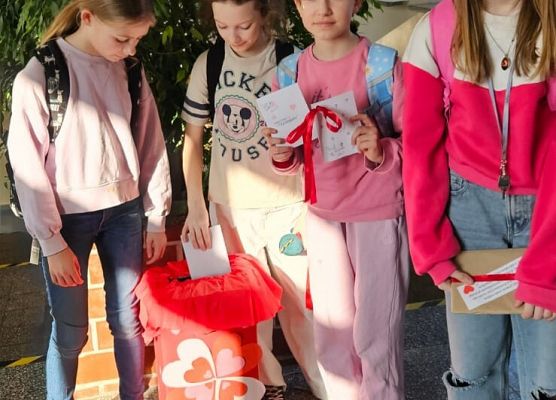 uczennice wkładają do skrzyneczki pocztę walentynkową